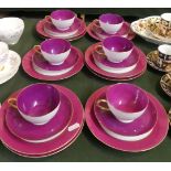A Collection of Maroon and Mauve Teacups, Saucers and Side Plates