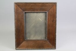 An Ebony Effect Carved Picture Frame.