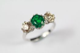 An 18ct White Gold Emerald and Diamond Three-stone Ring