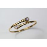 A Gold Amethyst and Diamond Bangle