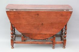 An 18th Century Walnut Gateleg Dining Table.