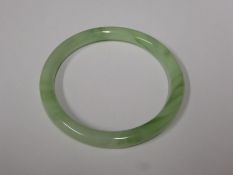 A Chinese Apple Green Jade-Style Bangle