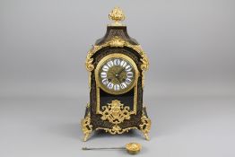 A 19th Century French Ebony and Ormolu Mantel Clock