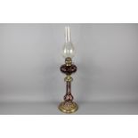 A English Cranberry Glass and Brass Oil Lamp
