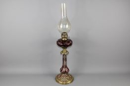 A English Cranberry Glass and Brass Oil Lamp