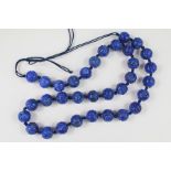 A String of Chinese Lapis Lazuli Carved Beads