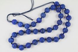 A String of Chinese Lapis Lazuli Carved Beads