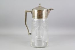 A Metal Topped Glass Cocktail Jug