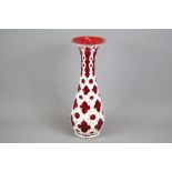 A Bohemian Cranberry and White Enamel Overlay Vase