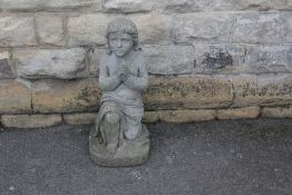 A Stone Figure of a Child Praying