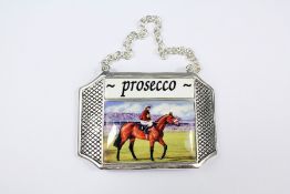A Silver-Plated and Enamel Proscecco Label