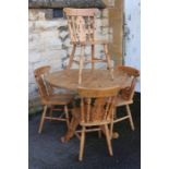 A Pine Circular Table and Four Chairs