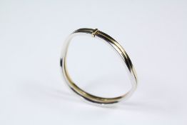 A Lady's 9ct Yellow and White Gold Bangle