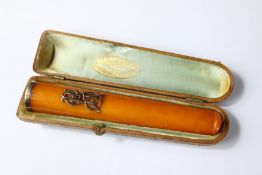 An Art Deco Amber and Gold Cigar Holder