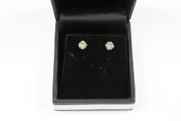 A Pair of White Gold Solitaire Diamond Stud Earrings