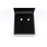 A Pair of White Gold Solitaire Diamond Stud Earrings