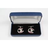 A Pair of Silver and Ruby Horseshoe Cufflinks