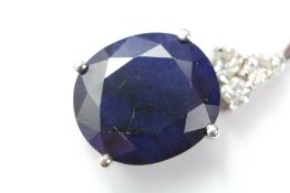 An 14ct White Gold and Midnight Blue Sapphire and Diamond Ring