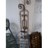 A CAST IRON WALL CANDLE SCONCE AND A VINTAGE MILK BOTTLE CARRIER