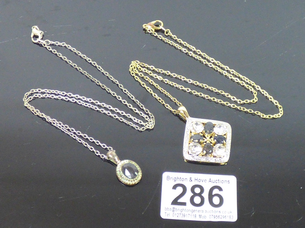 TWO COSTUME JEWELLERY PENDANTS ON CHAINS