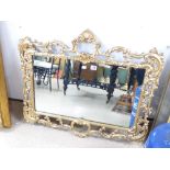 A DECORATIVE GILT FRAMED WALL MIRROR (94X80)