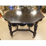 A VICTORIAN EBONISED ASTHETIC MOVEMENT OCTAGONAL CENTER TABLE, WITH CARVED DECORSTION ON STRETCHER