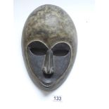 A 20TH CENTURY CARVED TRIBAL MASK