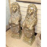 A PAIR OF STONE GARDEN FIGURE OF LIONS WITH SHIELDS 90CM HIGH