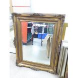 A DECORATIVE GILT FRAMED BEVELLED WALL MIRROR ( 70X94)