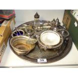 A CIRCULAR SILVER PLATED TRAY TOGETHER WITH A CONDIMENTS SET AND CUTLERY