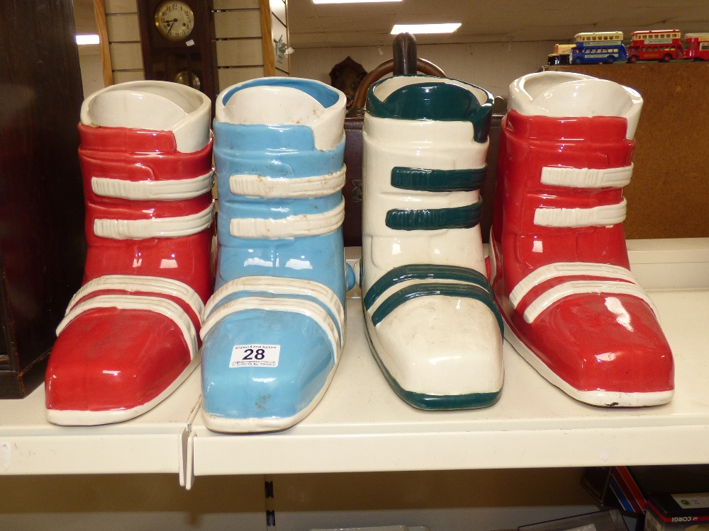 A SET OF FOUR CERAMIC VASES IN THE FORM OF SKI BOOTS