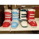 A SET OF FOUR CERAMIC VASES IN THE FORM OF SKI BOOTS