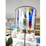 AN ECLECTIC TABLE LAMP WITH MULTICOLOURED GLASS DROPLETS