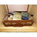 A SUITCASE OF MILITARY ITEMS BOTH ORIGINAL AND REPRODUCED INCLUDING ORIGINAL ANTI-GAS EYESHIELDS