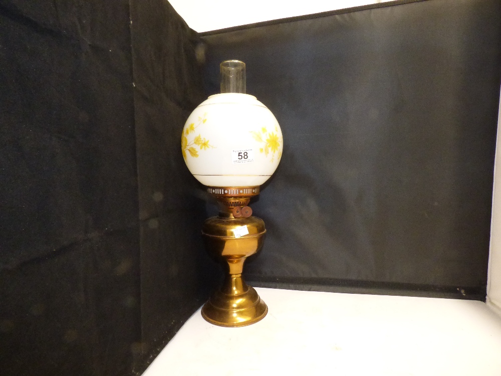 A BRASS OIL LAMP WITH SHADE
