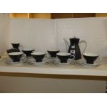 A ROSENTHAL BLACK AND WHITE TEA SET COMPRISING SIX CUPS AND SAUCERS, TEA COFFEE POT, MILK JUG AND