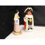 A FALCON WARE FIGURE "THE BRETON GIRL" AND BESWICK FIGURAL JUG OF A TOWN CRIER