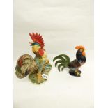 A JOHN RAYMOND POTTERY FIGURE OF A COCKEREL 22CM HIGH AND A LARGER CERAMIC COCKEREL 34 CM HIGH