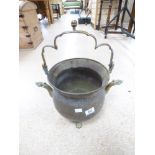 A BRASS BUCKET WITH BRASS SERPENT HEAD SPOUTS WITH SWING HANDLE ON CLAW FEET MARKED ON BASE VABELUX