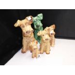 FIVE SYLVAC DOGS, FOUR BROWN AND ONE GREEN, LARGEST 28CM HIGH