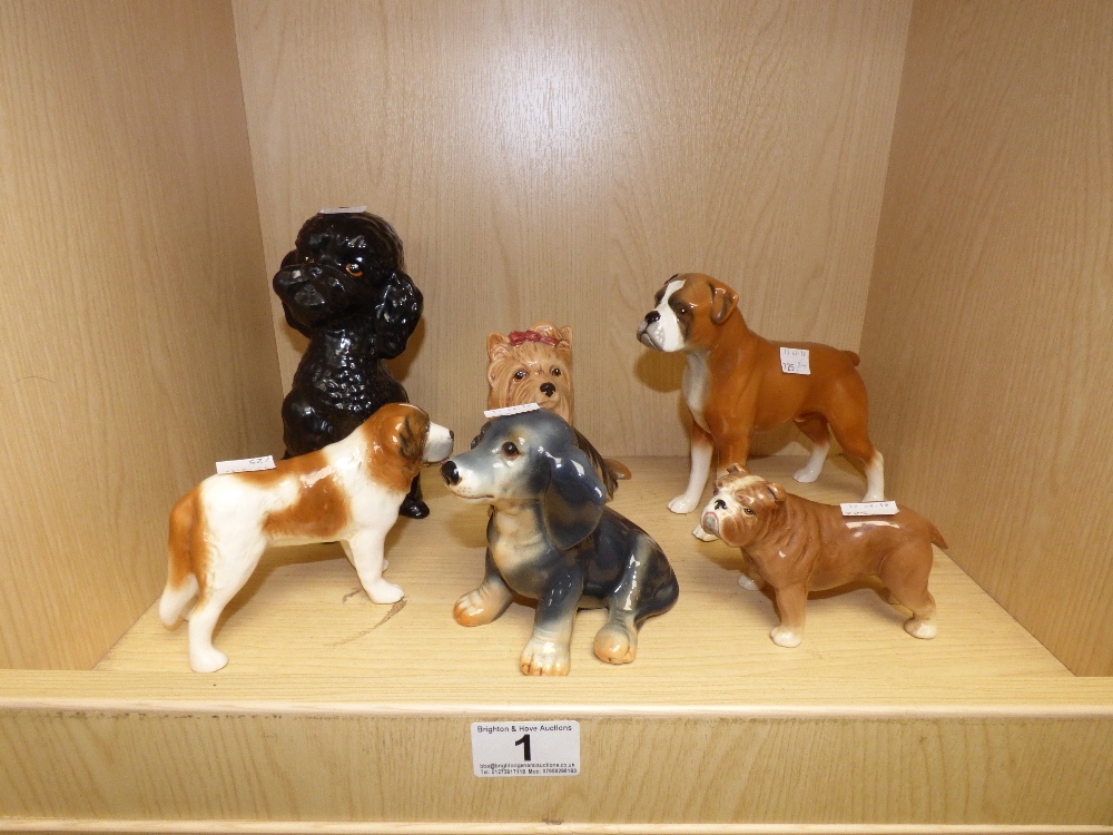 A BLACK SYLVAC POODLE, FOUR OTHER SYLVAC DOGS AND A PORCELAIN DOG