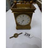 AN ORNATELY ENGRAVED BRASS CARRIAGE CLOCK WITH KEY MARKED HENRY ELLIS EXETER
