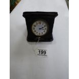 A THOMAS ARMSTRONG 8 DAY TRAVELLING CLOCK IN LEATHER CASE, MADE IN FRANCE