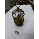 A VINTAGE GERMAN BIRD IN A CAGE AUTOMATON MECHANICAL CLOCK