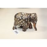 A LATE 19TH CENTURY CARVED WOODEN FIGURE OF AN ELEPHANT WITH INLAID IVORY DECORATION THROUGHOUT,