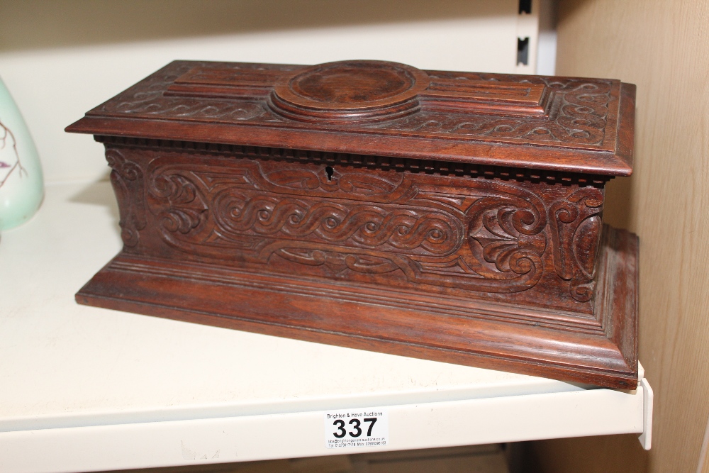 A HARDWOOD VINTAGE BOX WITH CASTELLATION FLORAL AND FLEUS DE LYS CARVED DECORATION