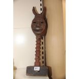 AN EASTERN WOODEN SCULPTURE OF A DEITY MASK WITH HORNS ON A BARLEY TWIST STEM 60CM TALL