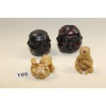 TWO CARVED WOOD FOUR FACED BUDDHAS TOGETHER WITH 2 UNUSUAL RESIN FIGURES OF BABIES