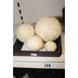 A SET OF FOUR LATE 19TH CENTURY GRADUATED IVORY WORKED BALLS, TOTAL WEIGHT 1.3KG