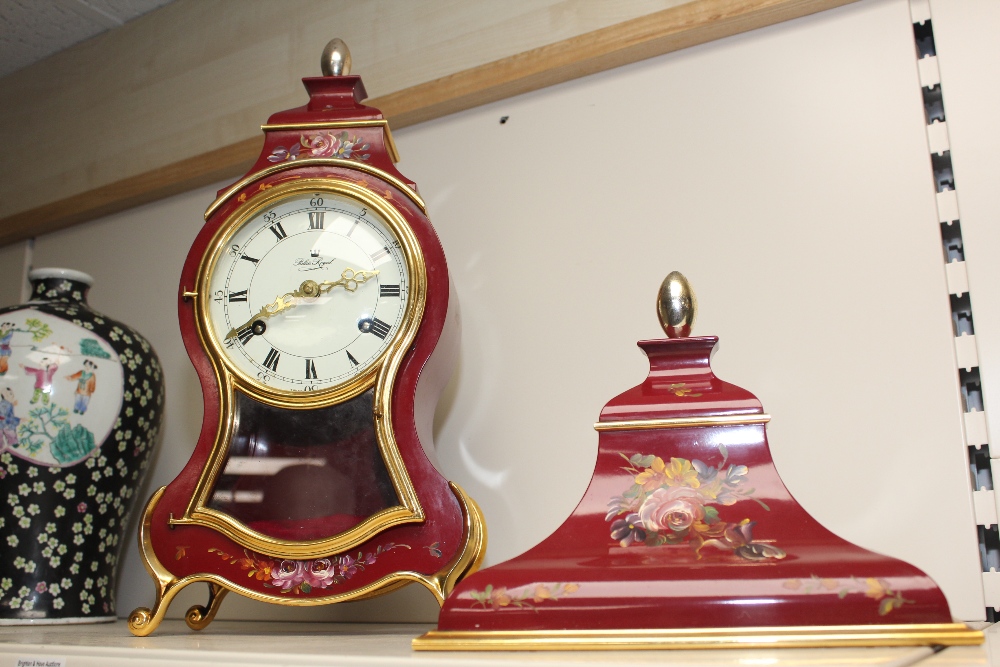 A REPRODUCTION FRENCH BOMBE SHAPED CLOCK AND SHELF WITH HAND PAINTED FLORAL DECORATION